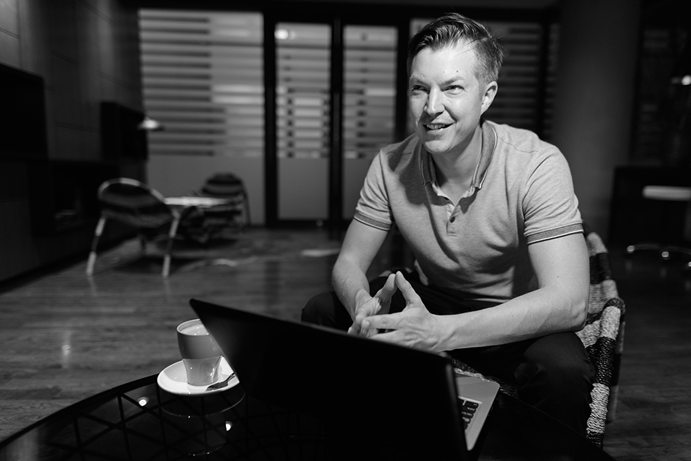 young handsome man using laptop in the living room